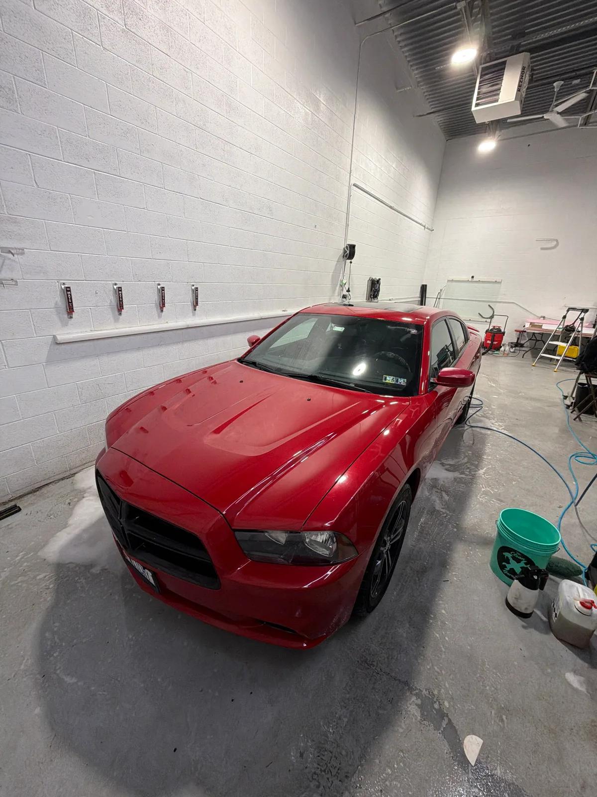 Red Dodge Charger in the detail bay — GNelson Detailing West Chester PA