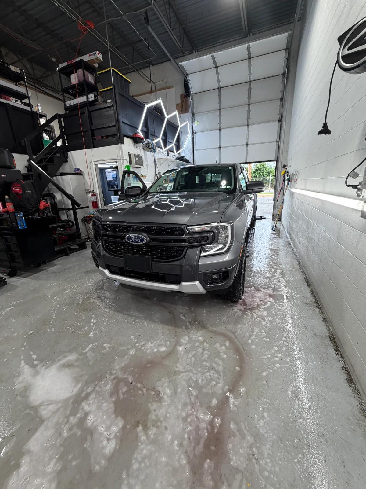 Grey Ford Ranger being rinsed down in the wash bay — GNelson Detailing