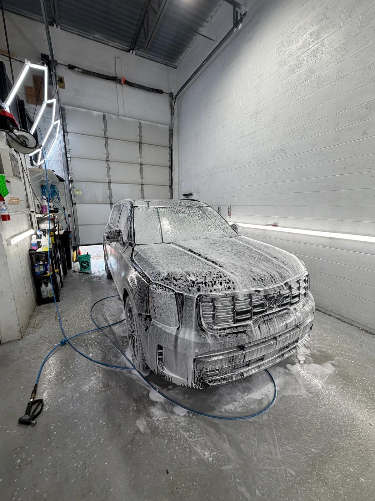 Kia Telluride covered in snow foam during a wash — GNelson Detailing