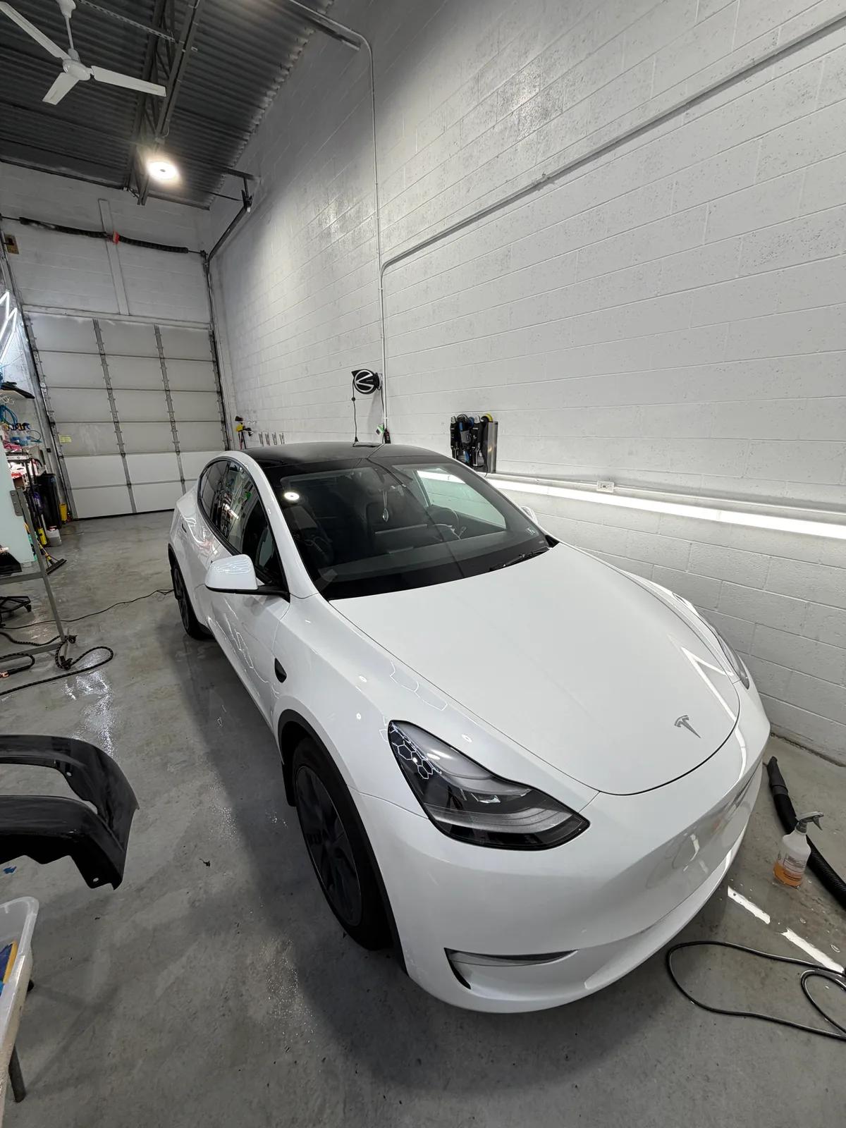White Tesla Model Y after full detail in the shop bay — West Chester PA